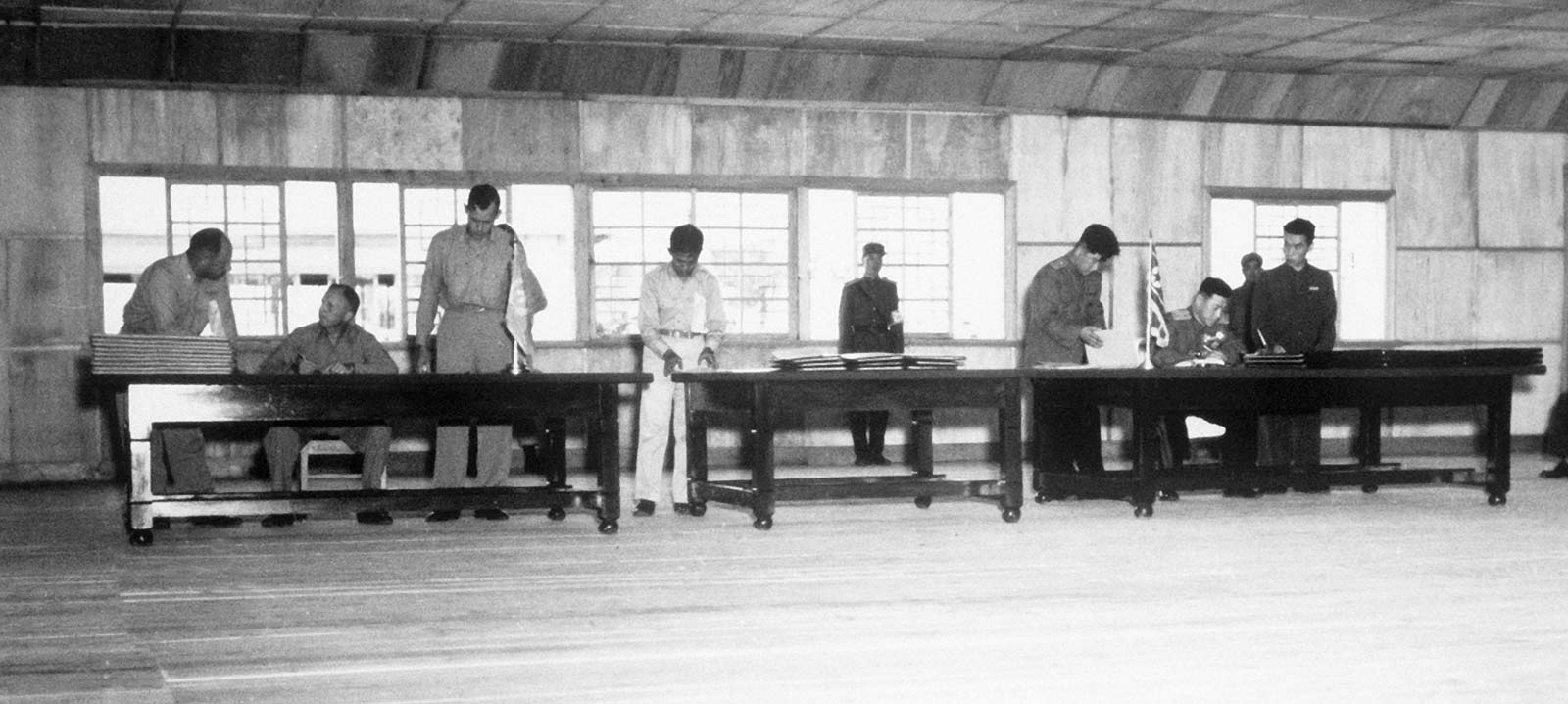 UN delegate Lieut. Gen. William K. Harrison, Jr. (seated left), and Korean People’s Army and Chinese People’s Volunteers delegate Gen. Nam Il (seated right) signing the Korean War armistice agreement at P’anmunjŏm, Korea, July 27, 1953