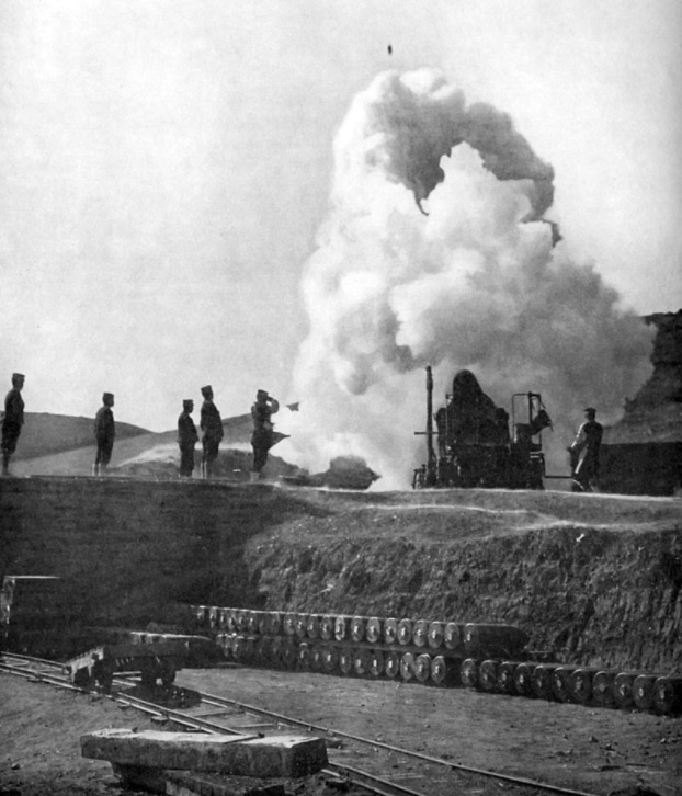Japanese 11-inch howitzer firing; shell visible in flight